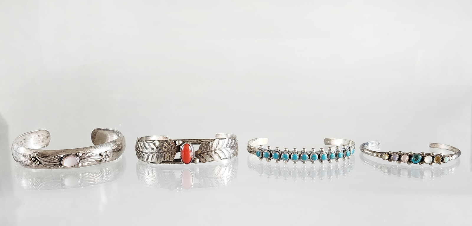 Lot of 4 Estate Vintage Native American Sterling Silver Cuff Bracelets: Lot of 4 Estate Vintage Native American Sterling Silver Cuff Bracelets. Including Carol Felley signed and 1985 dated, turquoise, coral and mother of pearl stones. Marks: CFD 85/ Sterling, other three