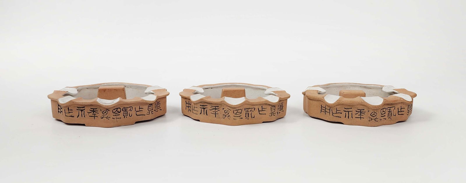 Lot of 3 Antique Chinese ROC Yixing Clay Ashtrays: Lot of 3 Antique Chinese ROC Yixing Clay Ashtrays , w. 5.5 inches, h. 1 inches, circa early to mid 20th century. Provenance: Estate of a New York collector/ dealer. The collection assembled between ea