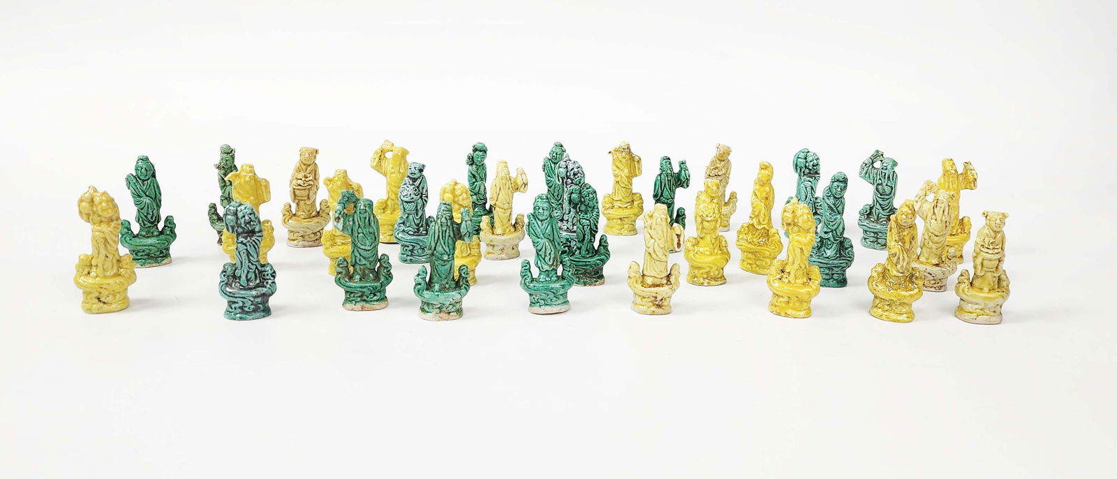 Group of 32 Chinese Green & Yellow Glazed Miniature Immortal Figures: Group of 32 Chinese Green & Yellow Glazed Miniature Immortal Figures, h. 2.25 inches, circa early to mid 20th century. Provenance: Estate of a New York collector/ dealer. The collection assembled betw