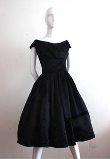 Christian Dior London Black Satin Cocktail Dress,c.1956: Christian Dior London Black Satin Cocktail Dress, c.1956. Labelled 'Christian Dior / U.K. Regd. / Made in England by/ Christian Dior Ltd London' and numbered '5697'.