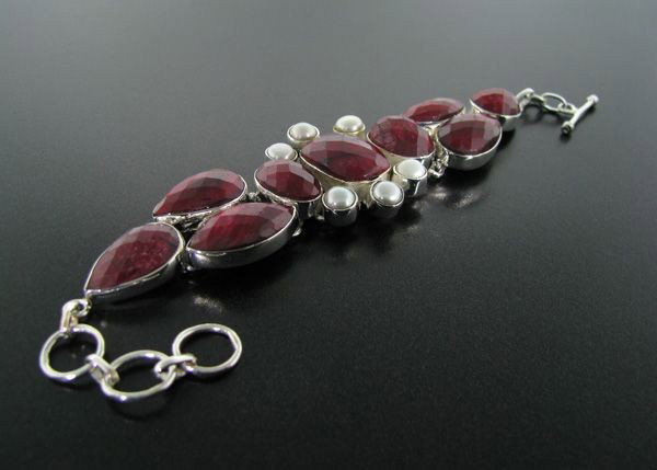 APP: 26k 91CT Ruby w/Pearls & Sterling Silver Bracelet: 91.92CT Ruby With Pearls and Sterling Silver Bracelet - Appraisal Value: $26.4K - Bid with utmost confidence from GovernmentAuction.com. We have been in business for over 35 years, and pride ourselves