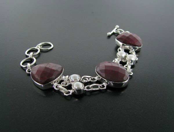 APP: 22k 78CT Ruby w/Pearls & Sterling Silver Bracelet: 78.92CT Ruby With Pearls and Sterling Silver Bracelet - Appraisal Value: $22.0K - Bid with utmost confidence from GovernmentAuction.com. We have been in business for over 35 years, and pride ourselves