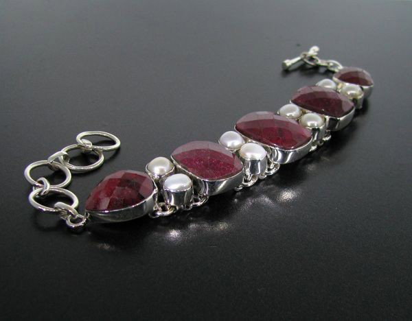 APP: 19k 65CT Ruby w/Pearls & Sterling Silver Bracelet: 65.79CT Ruby With Pearls and Sterling Silver Bracelet - Appraisal Value: $19.2K - Bid with utmost confidence from GovernmentAuction.com. We have been in business for over 35 years, and pride ourselves
