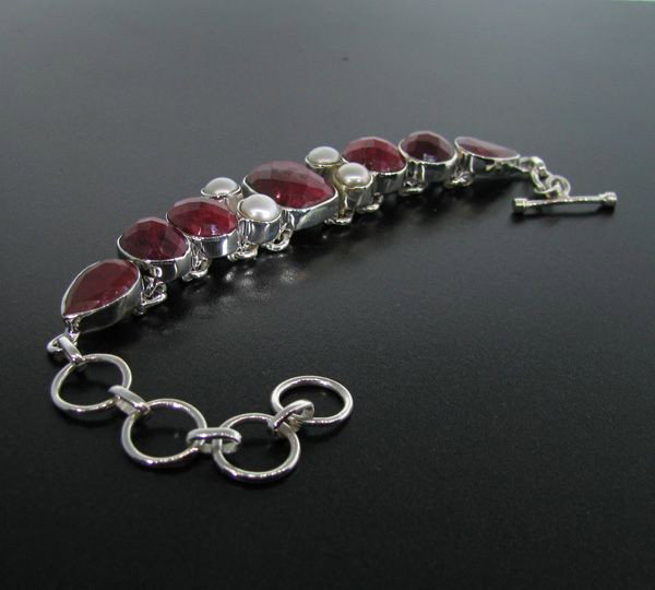 APP: 18k 46CT Ruby w/Pearls & Sterling Silver Bracelet: 46.62CT Ruby With Pearls and Sterling Silver Bracelet - Appraisal Value: $18.4K - Bid with utmost confidence from GovernmentAuction.com. We have been in business for over 35 years, and pride ourselves