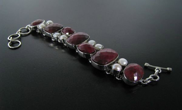APP: 16k 53CT Ruby w/Pearls & Sterling Silver Bracelet: 53.30CT Ruby With Pearls and Sterling Silver Bracelet - Appraisal Value: $16.3K - Bid with utmost confidence from GovernmentAuction.com. We have been in business for over 35 years, and pride ourselves