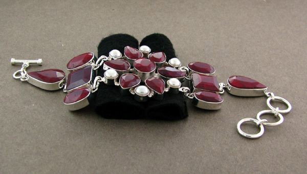 APP: 31k 136CT Ruby w/Pearls & Sterling Silver Bracelet: 136.19CT Ruby W/ Pearls and Sterling Silver Bracelet - Appraisal Value: $31.1K - Bid with utmost confidence from GovernmentAuction.com. We have been in business for over 35 years, and pride ourselves 