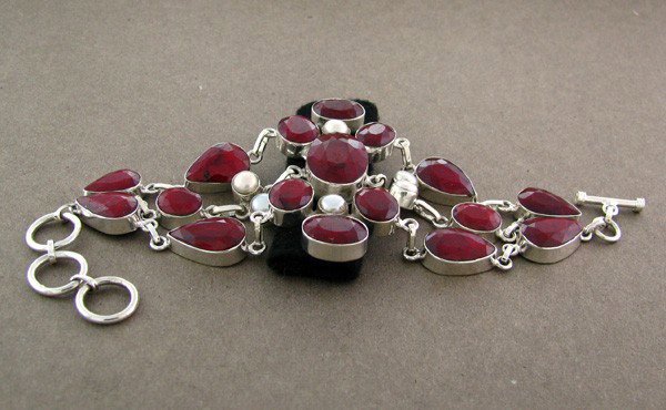 APP: 33k 145CTRuby w/Pearls & Sterling Silver Bracelet: 145.54CT Ruby W/ Pearls and Sterling Silver Bracelet - Appraisal Value: $33.1K - Bid with utmost confidence from GovernmentAuction.com. We have been in business for over 35 years, and pride ourselves 
