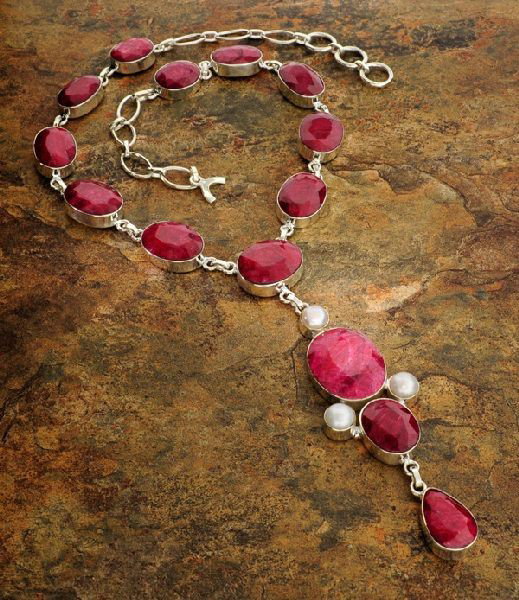 APP: 29k 208CTRuby w/Pearls & Sterling Silver Necklace: 208.43CT Ruby W/ Pearls ans Sterling Silver Necklace - Appraisal Value: $29.7K - Bid with utmost confidence from GovernmentAuction.com. We have been in business for over 35 years, and pride ourselves 