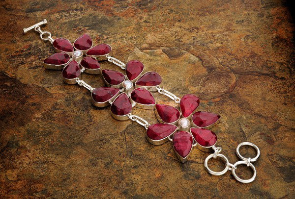 APP: 20k 110CTRuby w/Pearls & Sterling Silver Bracelet: 110.79CT Ruby W/ Pearls and Sterling Silver Bracelet - Appraisal Value: $20.0K - Bid with utmost confidence from GovernmentAuction.com. We have been in business for over 35 years, and pride ourselves 