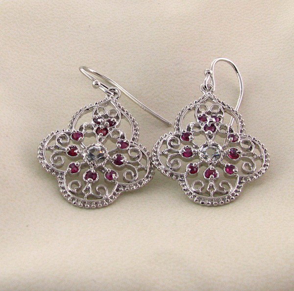 APP: 2k 2CT Ruby w/Colorless Topaz & Silver Earrings: 2.21CT Ruby W/ Colorless Topaz and Platinum Overlay Sterling Silver Earrings - Appraisal Value: $1.9K - Bid with utmost confidence from GovernmentAuction.com. We have been in business for over 35 year