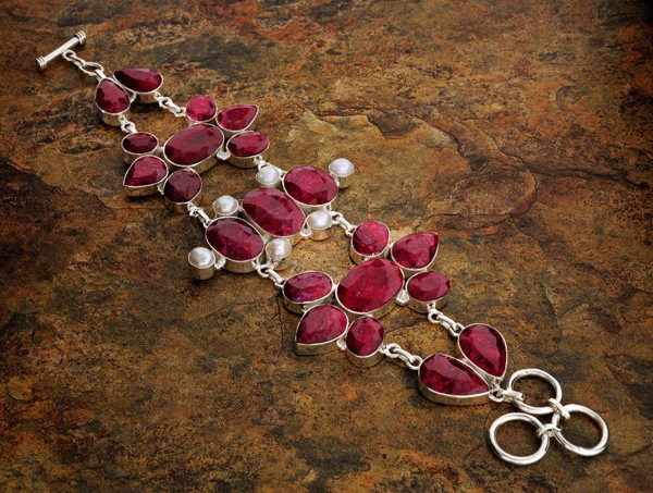 APP: 36k 217CTRuby w/Pearls & Sterling Silver Bracelet: 217.83CT Ruby W/ Pearls and Sterling Silver Bracelet - Appraisal Value: $36.3K - Bid with utmost confidence from GovernmentAuction.com. We have been in business for over 35 years, and pride ourselves 
