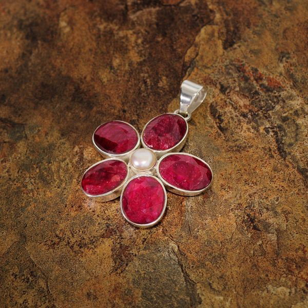 APP: 9k 31CTRuby w/Pearls & Sterling Silver Pendant: 31.78CT Ruby With Pearls and Sterling Silver Pendan - Appraisal Value: $9.8K - Bid with utmost confidence from GovernmentAuction.com. We have been in business for over 35 years, and pride ourselves on