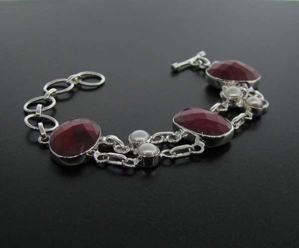 APP: 17k 43CTRuby w/Pearls & Sterling Silver Bracelet: 43.19CT Ruby With Pearls and Sterling Silver Bracelet - Appraisal Value: $16.9K - Bid with utmost confidence from GovernmentAuction.com. We have been in business for over 35 years, and pride ourselves