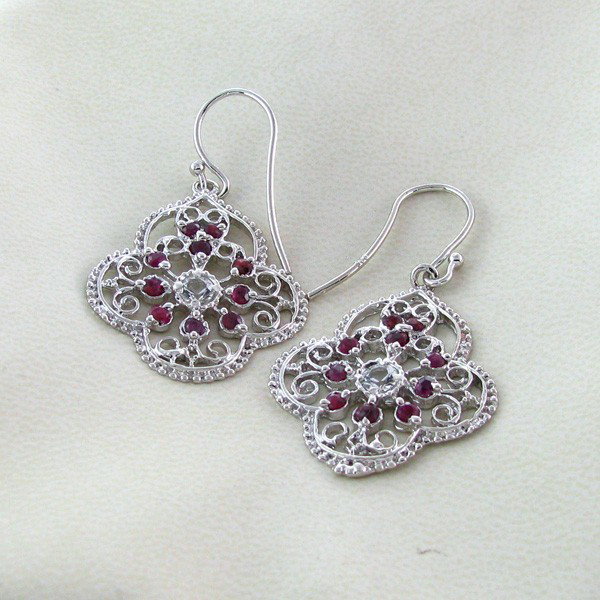 APP: 1k 1CT Ruby w/Topaz & Plat Sterl Silver Earrings: 1.90CT Ruby W/Topaz and Platinum Overlay Sterling Silver Earrings - Appraisal Value: $1.8K - Bid with utmost confidence from GovernmentAuction.com. We have been in business for over 35 years, and prid