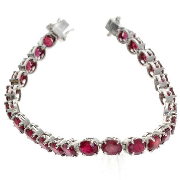 APP: 20k 22 CT Oval Cut Ruby & Sterling Silver Bracelet: 22.67CT Oval Cut Ruby and Sterling Silver Bracelet - Appraisal Value: $20.3K