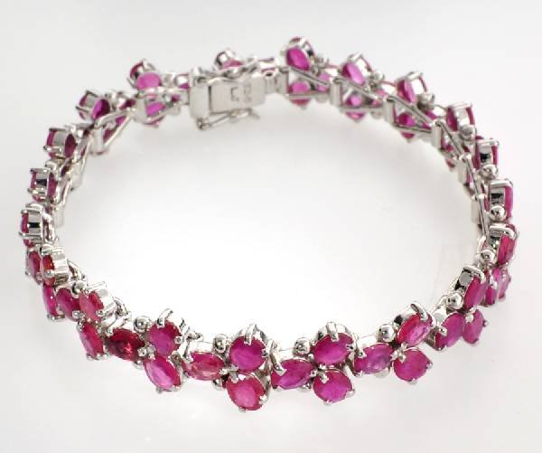 APP: 25k 24CT Oval Cut Ruby & Sterl Silver Bracelet: 24.76CT Oval Cut Ruby and Platinum Over Sterling Silver Bracelet - Appraisal Value: $25.7K