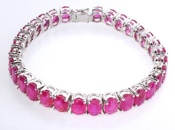 APP: 20k 25CT Oval Cut Ruby & Sterl Silver Bracelet: 25.35CT Oval Cut Ruby and Platinum Over Sterling Silver Bracelet - Appraisal Value: $20.6K
