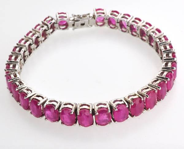 APP: 21k 26CT Oval Cut Ruby & Sterl Silver Bracelet: 26.28CT Oval Cut Ruby and Platinum Over Sterling Silver Bracelet - Appraisal Value: $21.2K