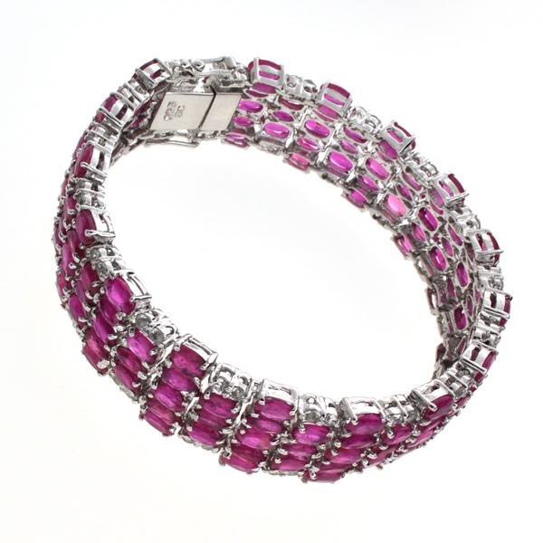 APP: 22k 33CT Ruby & Topaz Sterl Silver Bracelet: 33.28CT Ruby and Topaz Platinum Over Sterling Silver Bracelet - Appraisal Value: $22.2K