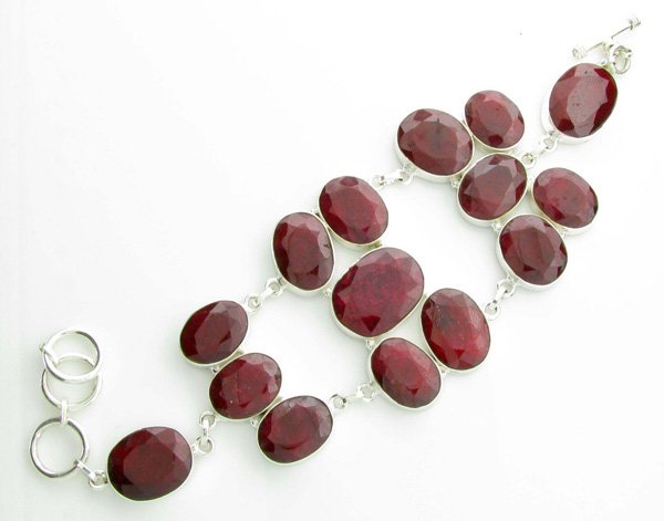 APP: 12k 59CT Oval Cut Ruby & Sterl Silver Bracelet: 59.10CT Oval Cut Ruby and Platinum Over Sterling Sil