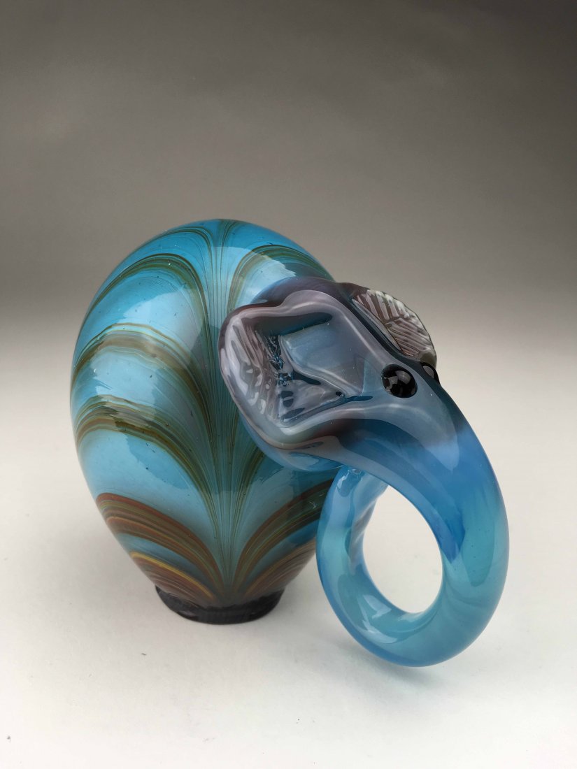 Art Glass Elephant: This art glass elephant is hand blown and includes a variety of cool colors. Has a crown logo on the bottom as well as a signature.(5x5x3)