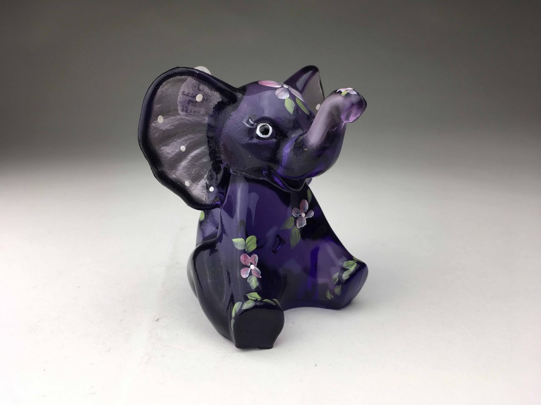 Fenton Purple Elephant: This Fenton Elephant is Purple in color with flower accents throughout. Is marked Fenton and does have original Fenton price tag(4x3x3)