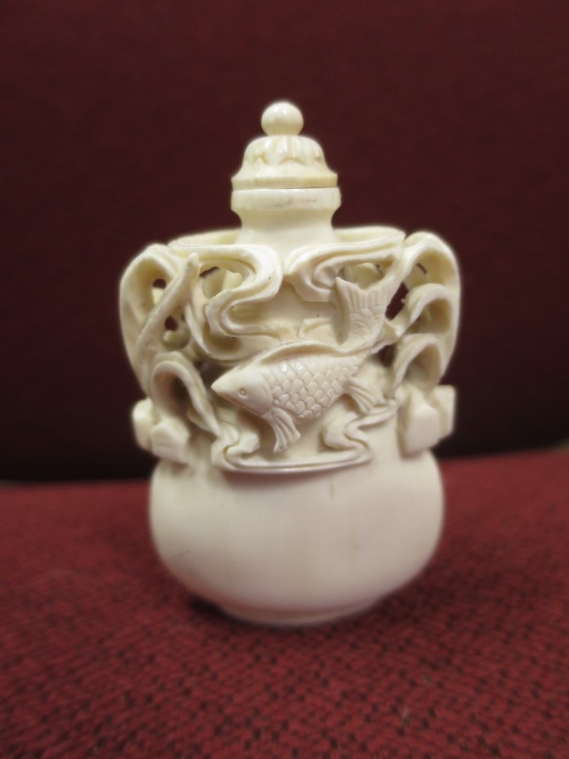 White chinese carved snuff bottle with Koi fish design.: White chinese carved snuff bottle with Koi fish design.