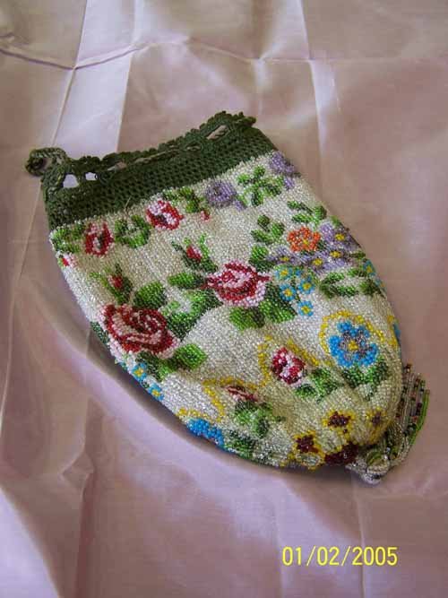 Vintage Floral Beaded Purse: Beautiful vintage antique beaded purse.Dark moss colored crochet trim around the top of the purse.Floral Theme Dark red and light pink roses ,blue ,orange lavender ascent flowers, Dark and light green