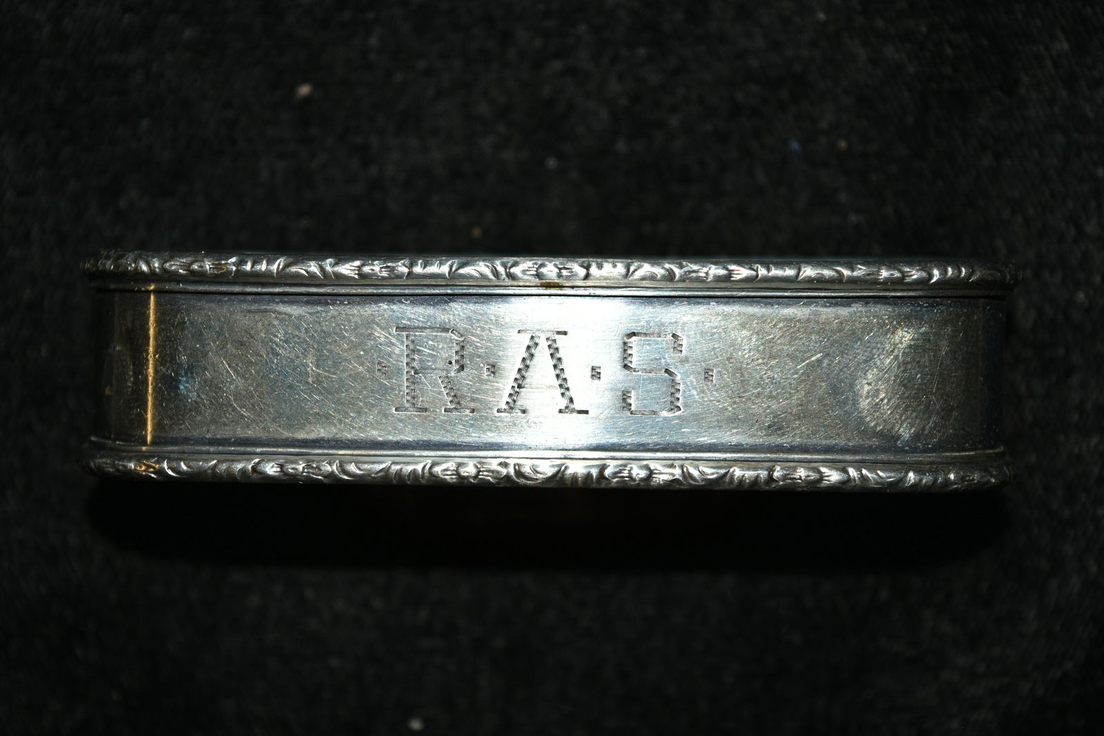 Antique Sterling Napkin Ring With Decorated Boarders.: Antique Sterling Napkin Ring With Decorated Boarders. 25.6 Grams. Measures 3"