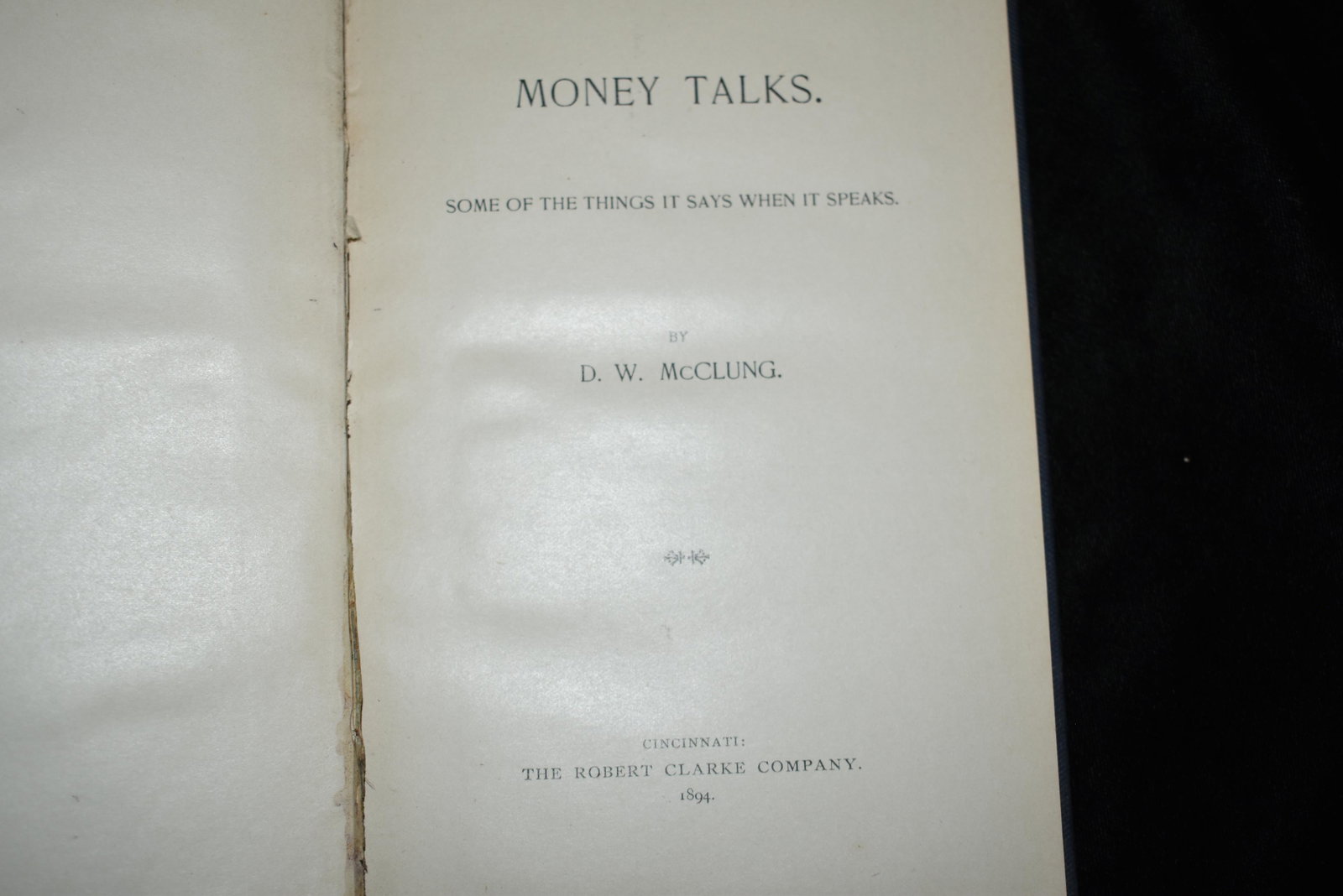 Money Talks 1894 1st Ed D.W. McClung: Money talks. Some of the things it says when it speaks by D W McClung Published by The Robert Clarke Company 1894. 1st Edition. Original hardback in blue cloth with gold print. Very good condition. Mi
