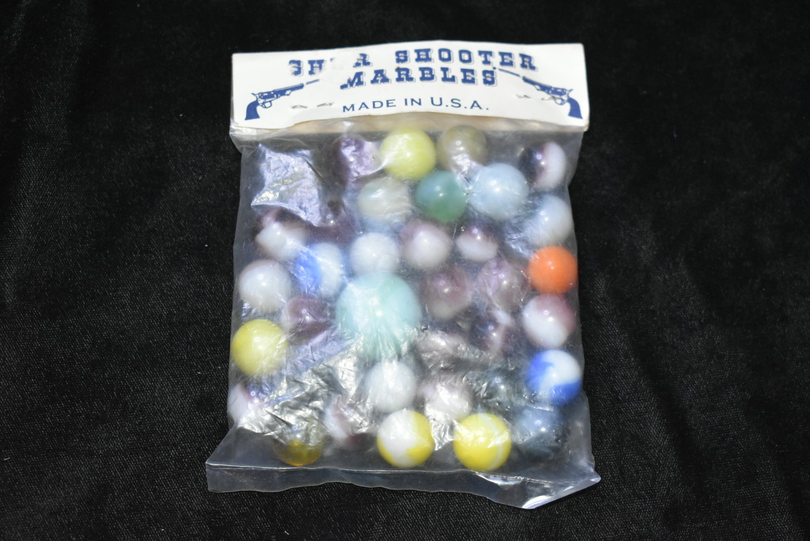 1940's Shur Shooter Marbles 40: 1940's Shur Shooter Marbles 40 40 Shur Shooter Marbles from the 1940's in their original bag. All marbles are in unused condition/mint. Bag is 5" by 4" Largest Marble the green shooter is 1"