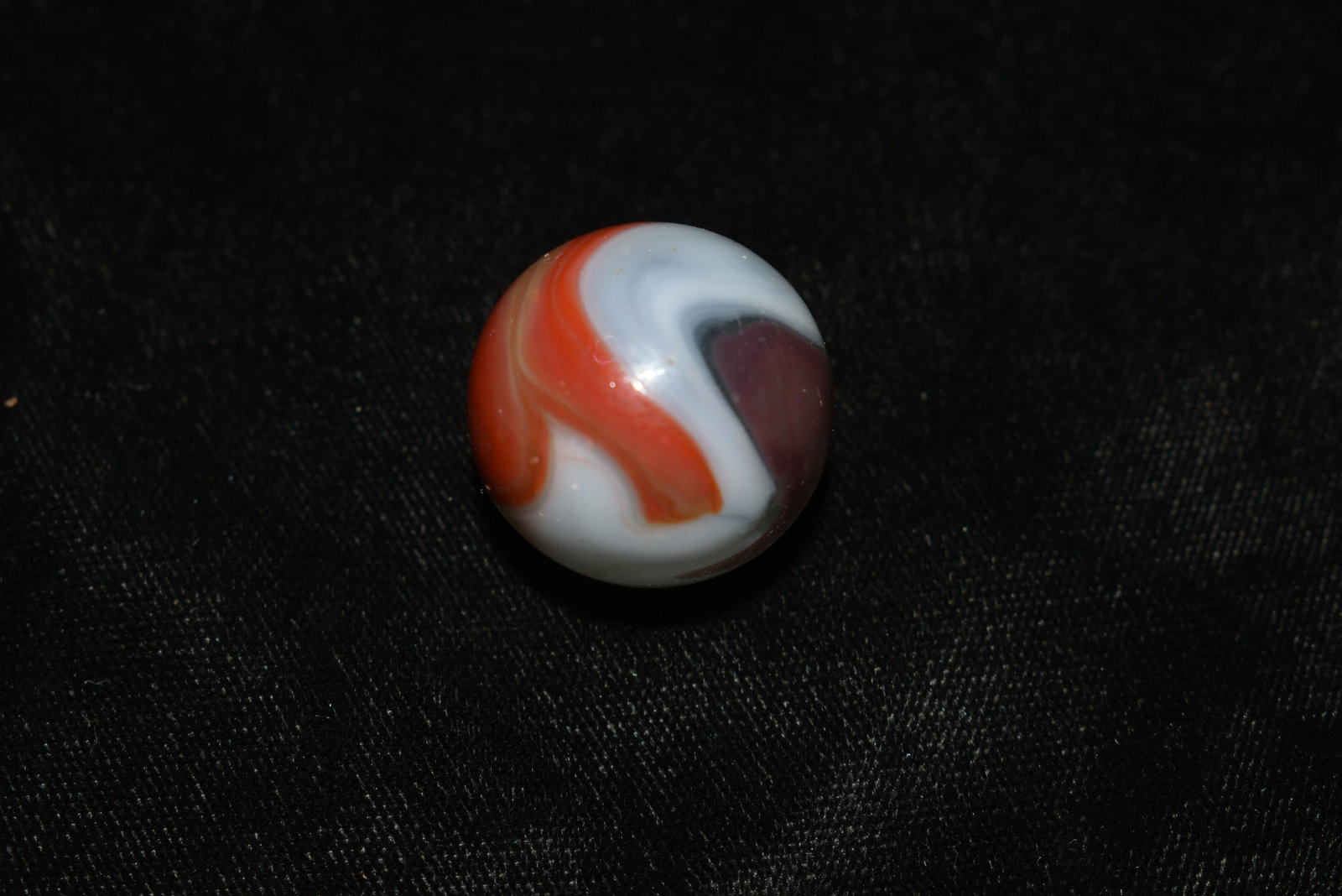 Tri-Color Vitro Swirl Marble: VITRO AGATE COMPANY, Swirl. Opaque white base. Swirls of transparent red with some translucent brown edging. Parkersburg WV, circa 1945-1955. 15/16". Very Good Condition.
