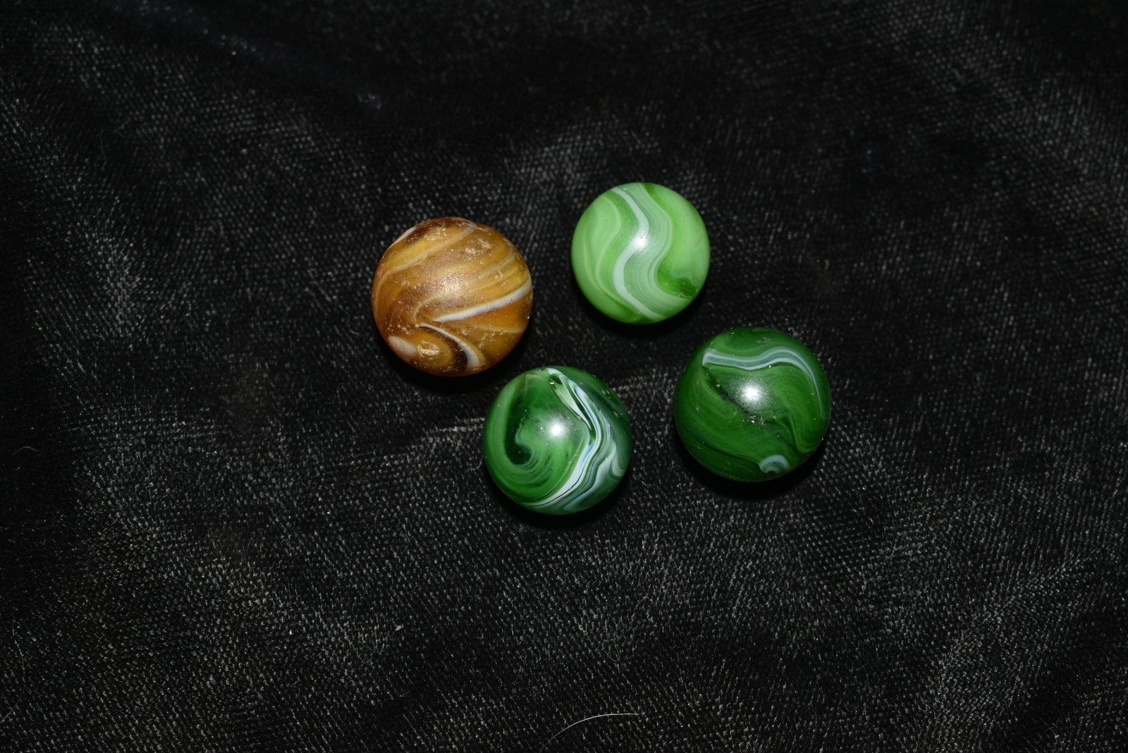 4 Christensen Slag Marbles: 4 MF Christensen Hand Gathered Slag Marbles. Late 1920's to 1930's. 3 Green and One Brick. 2 of the greens are excellent. The other two saw a good amount of game play but are still in good shape.