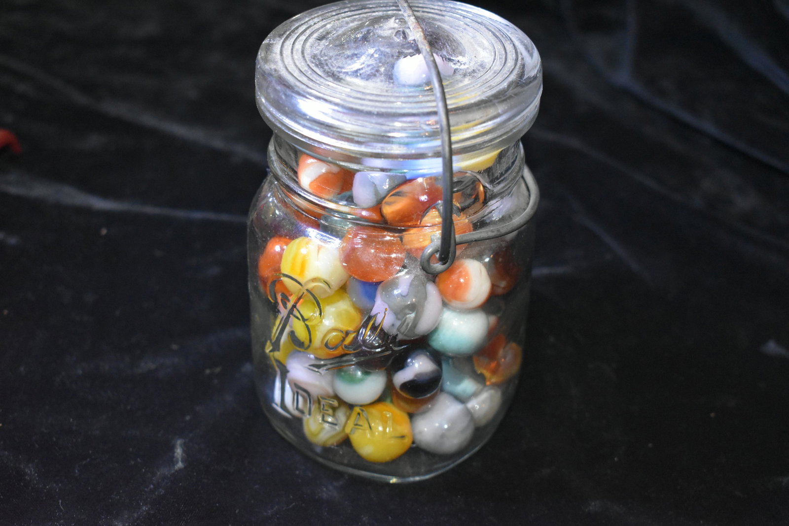 Old Mason Jar Full of Colorful Marbles: Mason Jar with around 100 colorful marbles. 1970's to present. 1/2" to 3/4" marbles. All in excellent condition. Jar is 5 1/5" by 3 1/8".