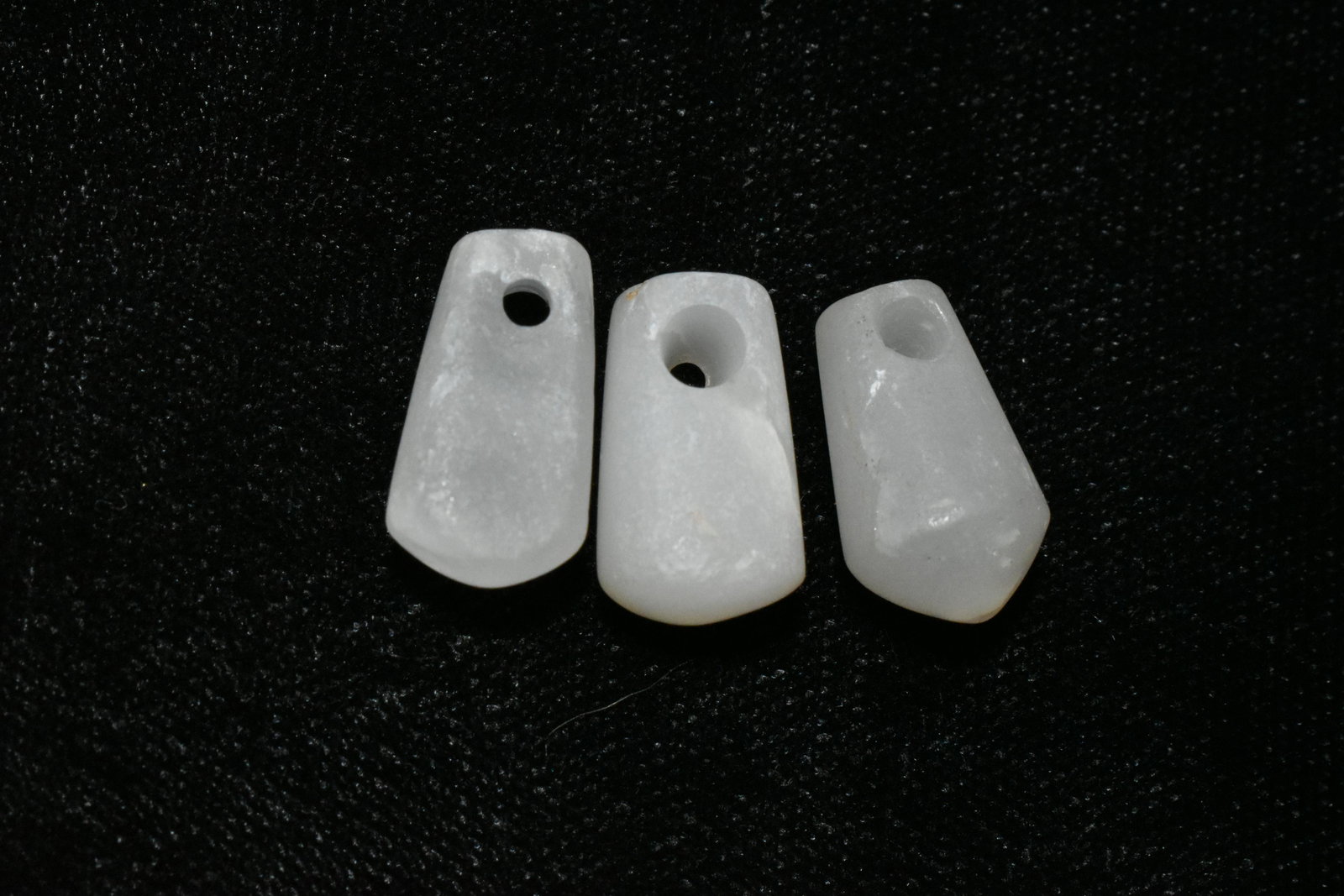A trio of choice Tairona milky crystal pendants from: A trio of choice Tairona milky crystal pendants from Colombia, ca. 1000 â€“ 1500 AD. These beautiful translucent examples are 5/8” long, are highly polished and drilled for suspension.