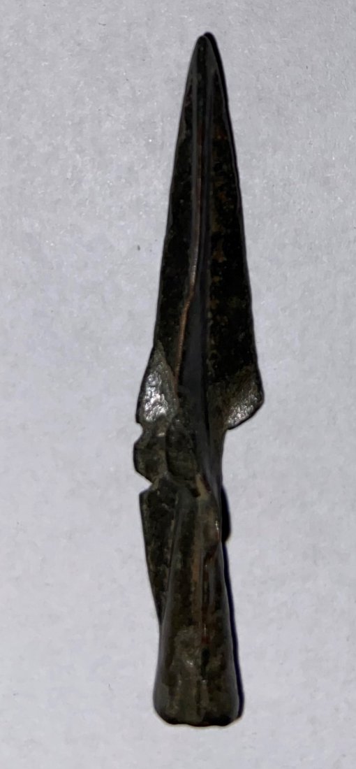 1-7/8" Scythian Trilobite Arrowhead, ca. 750-350: A fine Scythian trilobite arrowhead from Central Asia, ca. 750 â€“ 350 BC. This excellent bronze example is 1-7/8" long, has a hollow socket and good mineral deposits.