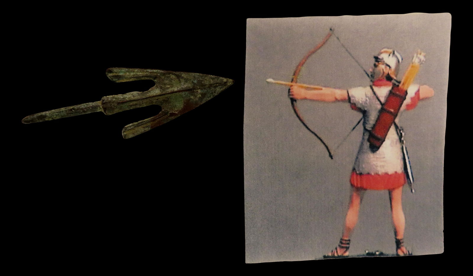 Bronze/Copper Arrowhead with a copied photo of a Roman shooting a Bow and Arrow. Please see photos (1 of 4)