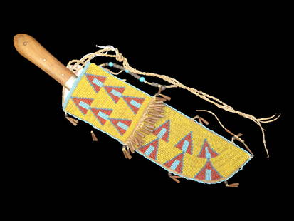 Outstanding Sioux Beaded Sheath & Indian Trade Knife. Elaborate Beadwork, Heavily Adorned with: Outstanding Sioux Beaded Sheath & Indian Trade Knife. Elaborate Beadwork, Heavily Adorned with numerous drops and bangles, Fringe across the middle with tinkler cones as well, 10 Small drops surroundi