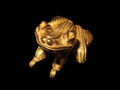 1 3/8" Pre-Columbian Tairona Gold Frog Pendant, An ancient Pre-Columbian Tairona figure: 1 3/8" Pre-Columbian Tairona Gold Frog Pendant, An ancient Pre-Columbian Tairona figure crafted from tumbaga - a gold-copper alloy- depicting a frog with pointed eyes and nose. The frogs back is adorn