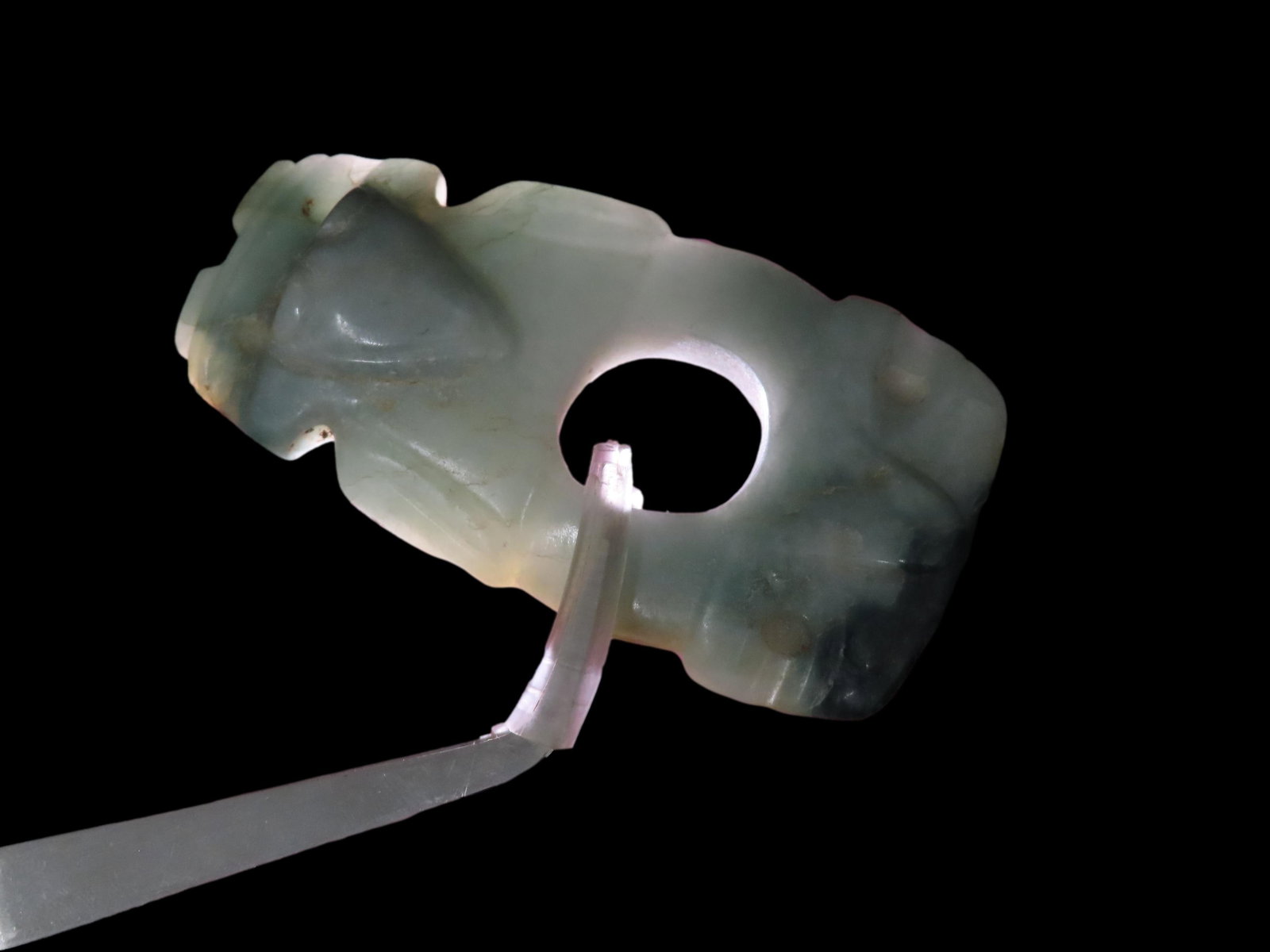 Phenomenal Museum Grade Dual Bird Effigy Jade Axe God Pendant. Costa Rica. Motley COA. Highly: Phenomenal Museum Grade Dual Bird Effigy Jade Axe God Pendant. Costa Rica. Motley COA. Highly Translucent blue jade with phenomenal polish. Rare style with the central perforation for decoration or to