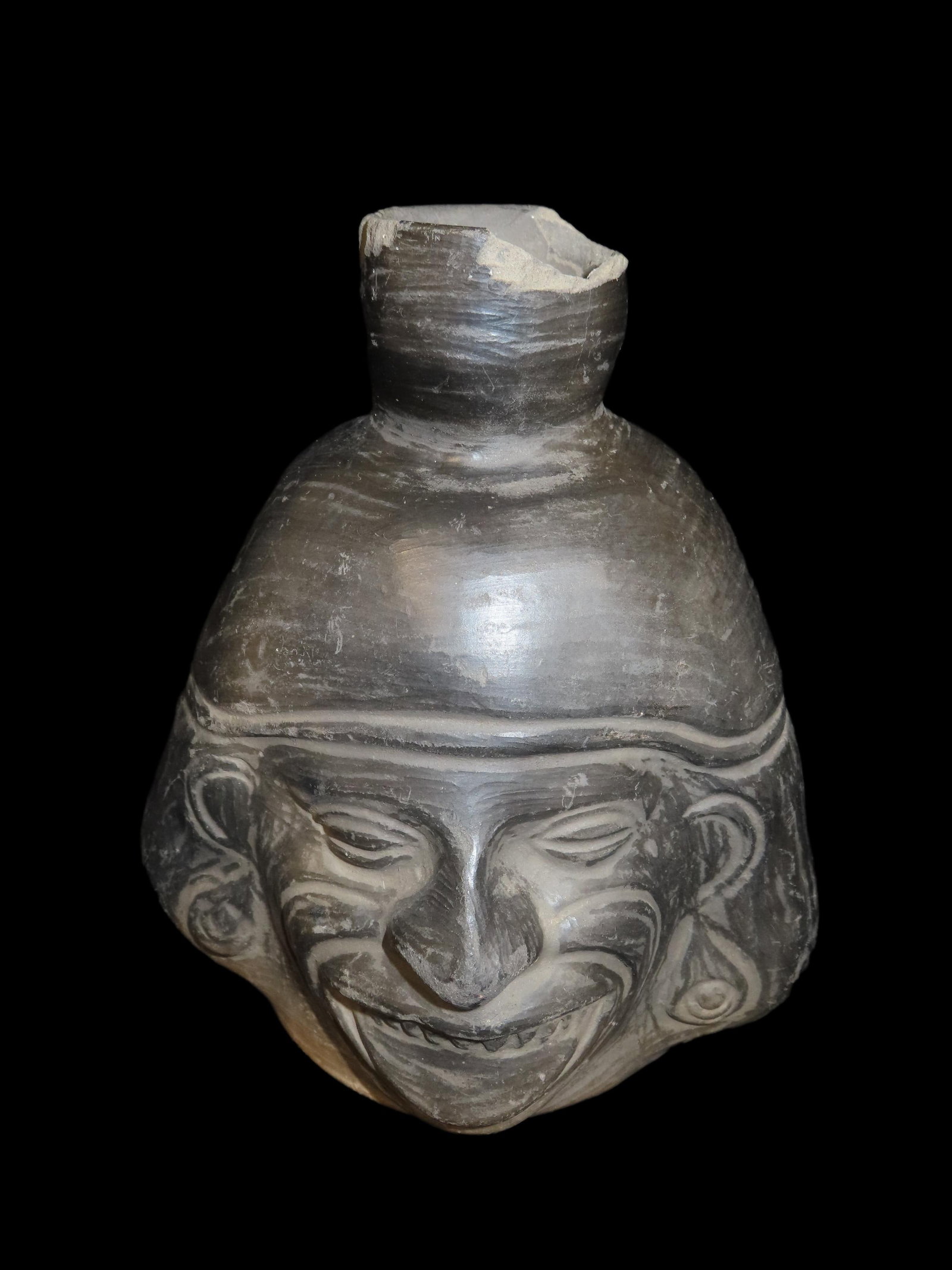 Outstanding Inca Portrait Vessel of a Warrier / Chief with Filed Down Teeth. Peru. Nice Solid: Outstanding Inca Portrait Vessel of a Warrier / Chief with Filed Down Teeth. Peru. Nice Solid Blackware Pottery vessel, No restoration, small chips at rim. Measures 7 1/2" tall by 6 1/4" Wide. Great E