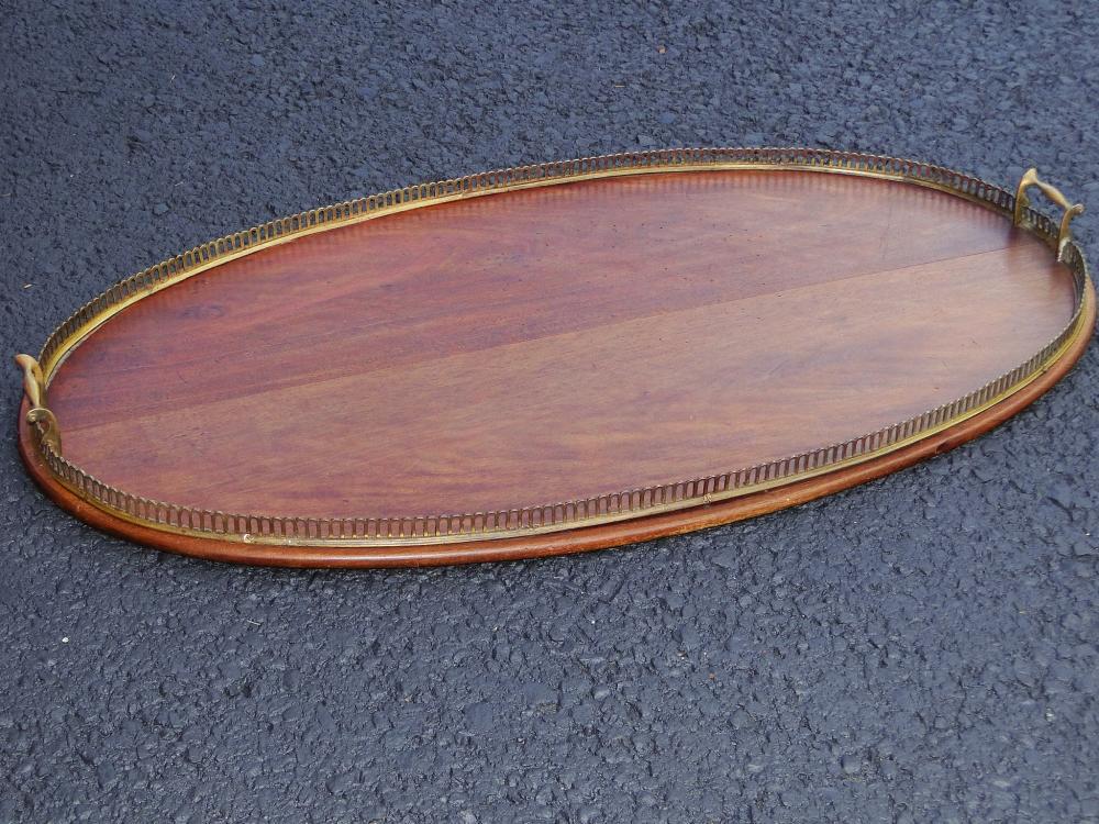 19TH C LARGE WOODEN OVAL TRAY: 19TH C LARGE WOODEN OVAL TRAY WITH BRASS BORDER ENCOMPASSING THE OUTER EDGE, 21 X 36