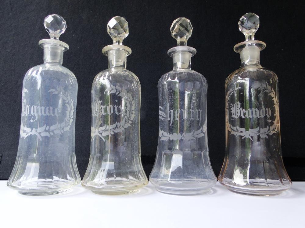 GROUPING OF FOUR ETCHED BAR BOTTLES: GROUPING OF FOUR ETCHED BAR BOTTLES 11' EACH WITH STOPPERS