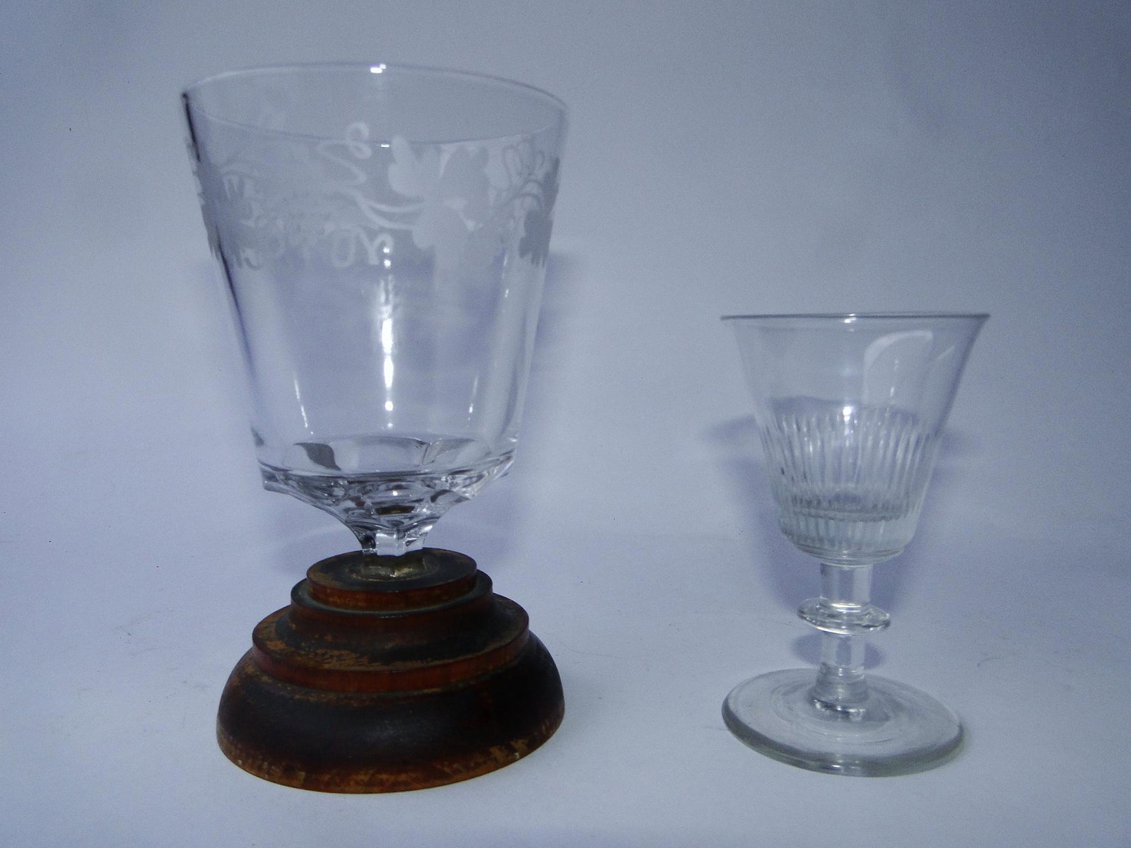 TWO EARLY GLASS ITEMS, MAKE DO WINE GLASS / WHEEL: TWO EARLY GLASS ITEMS, MAKE DO WINE GLASS / WHEEL ETCHED GRAPE, LEAF, VINE DECOR WITH A MAKE DO WOODEN BASE 5.75 X 3.5, 19TH C FLINT "SPIRITS" GLASS