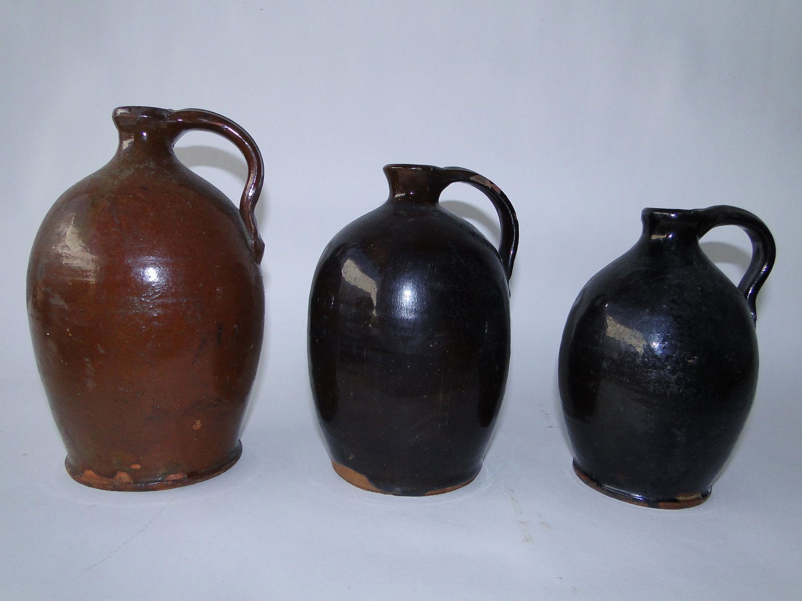 THREE MISC. REDWARE JUGS (1 of 3)