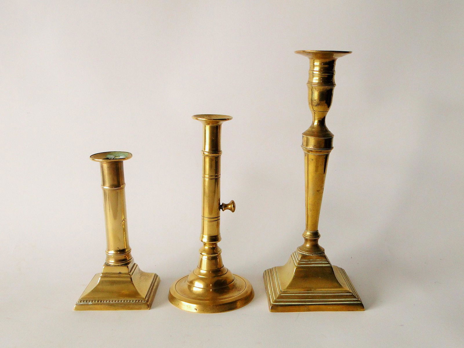 GROUPING OF EARLY BRASS CANDLESTICKS (1 of 1)