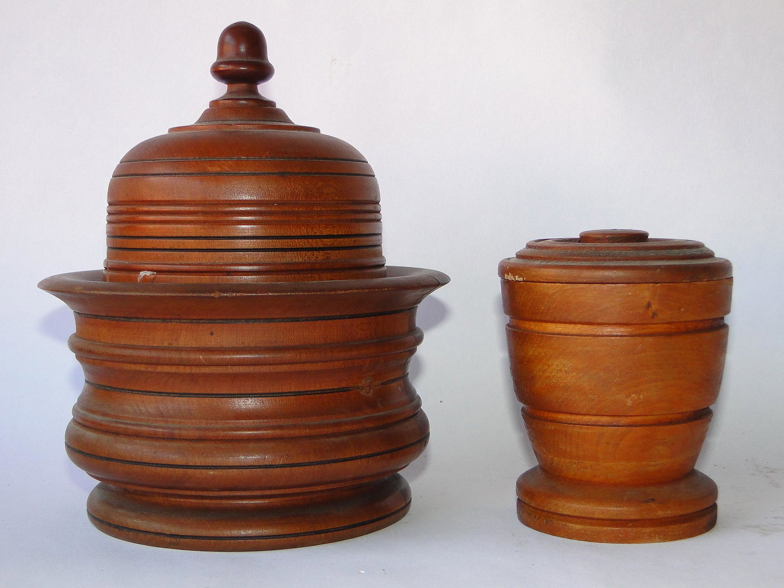 TWO 19TH C MAPLE CANNISTERS: TWO 19TH C MAPLE CANNISTERS, TURNED, IN OLD COLOR, 7", 4"