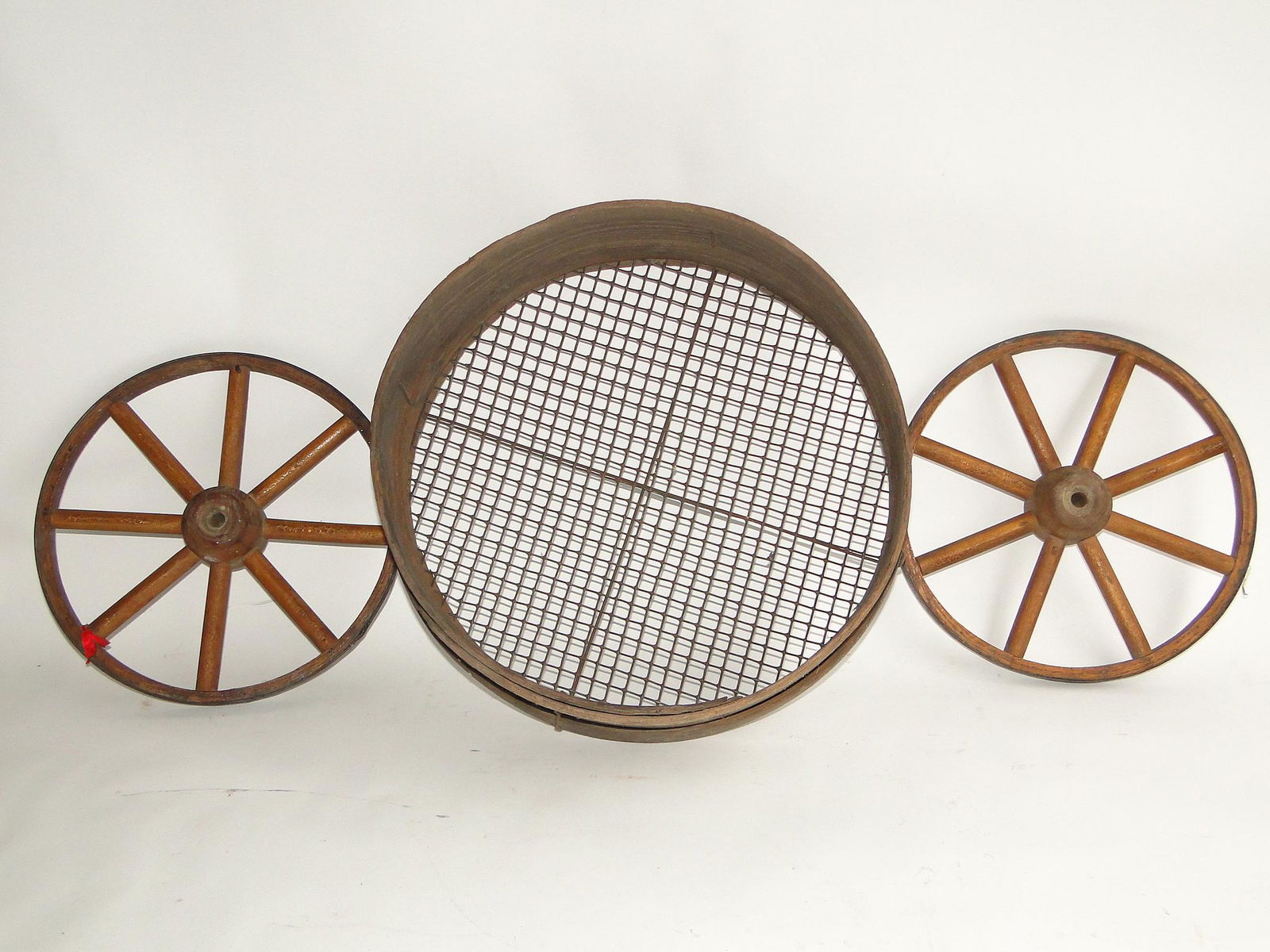 GROUPING OF SIEVE, TWO WOODEN WAGON WHEELS (1 of 1)
