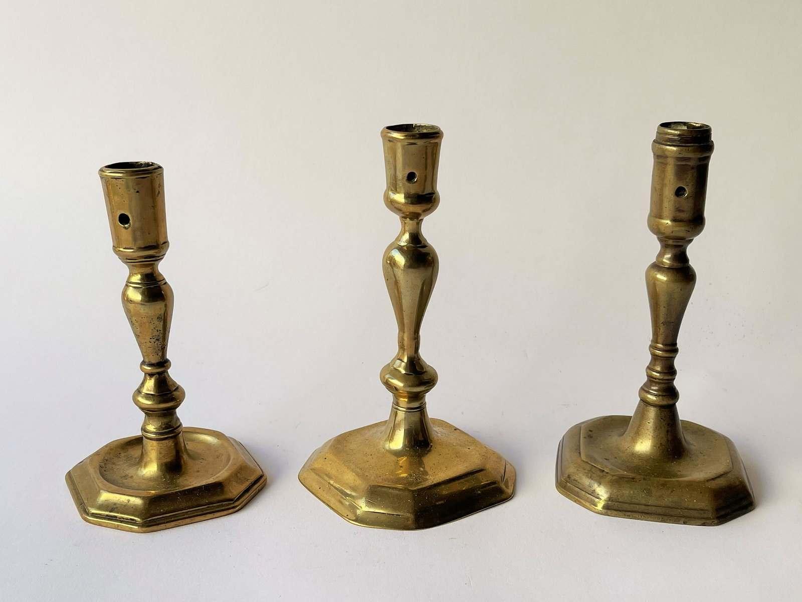 THREE EARLY 18TH C ENGLISH BRASS CANDLESTICKS (1 of 3)