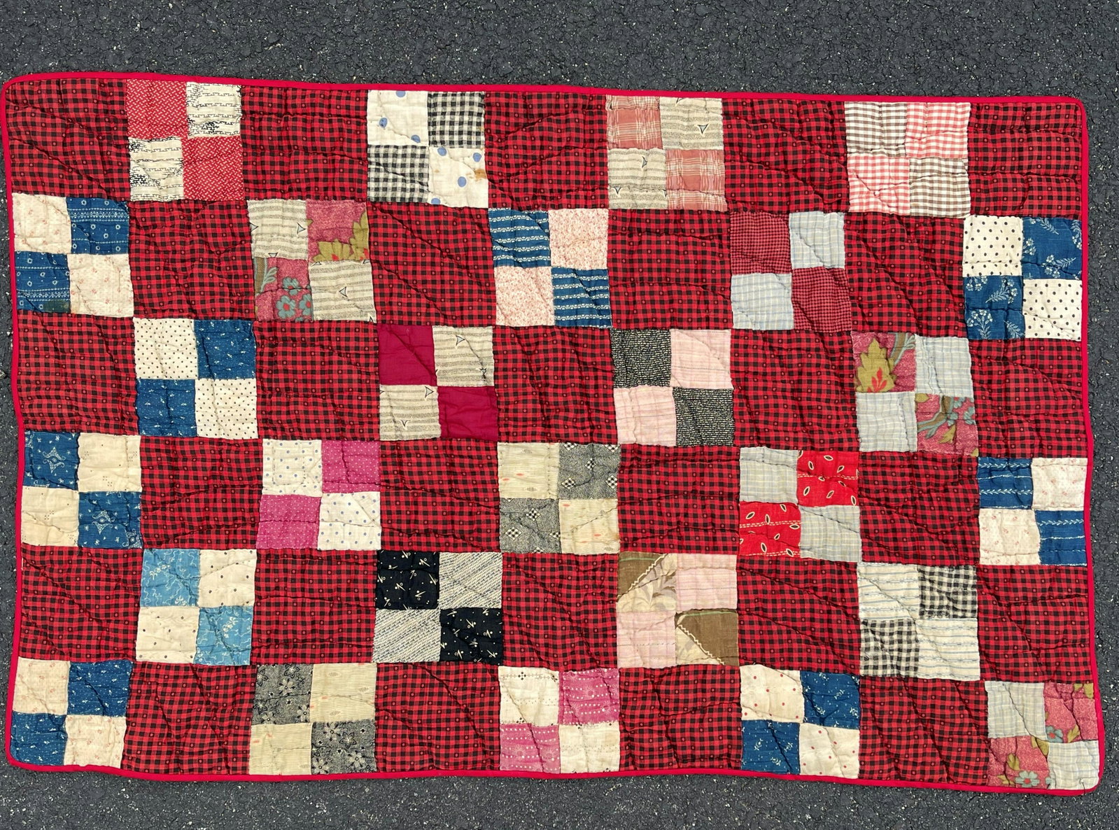 1890 BABY'S QUILT: 1890 BABY'S QUILT 22 X 35 HAND SEWN RED AND BLUE GINGHAM SQUARES WITH BLUE GINGHAM BACK WITH ADDITIONAL CRESCENT QUILTING AND RED BINDING